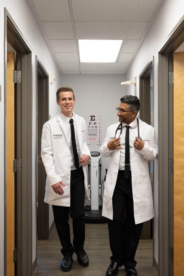 Dr. Tyler George MD and Dr. James Broadbent DO walking through Parker Medical hallway Las Vegas