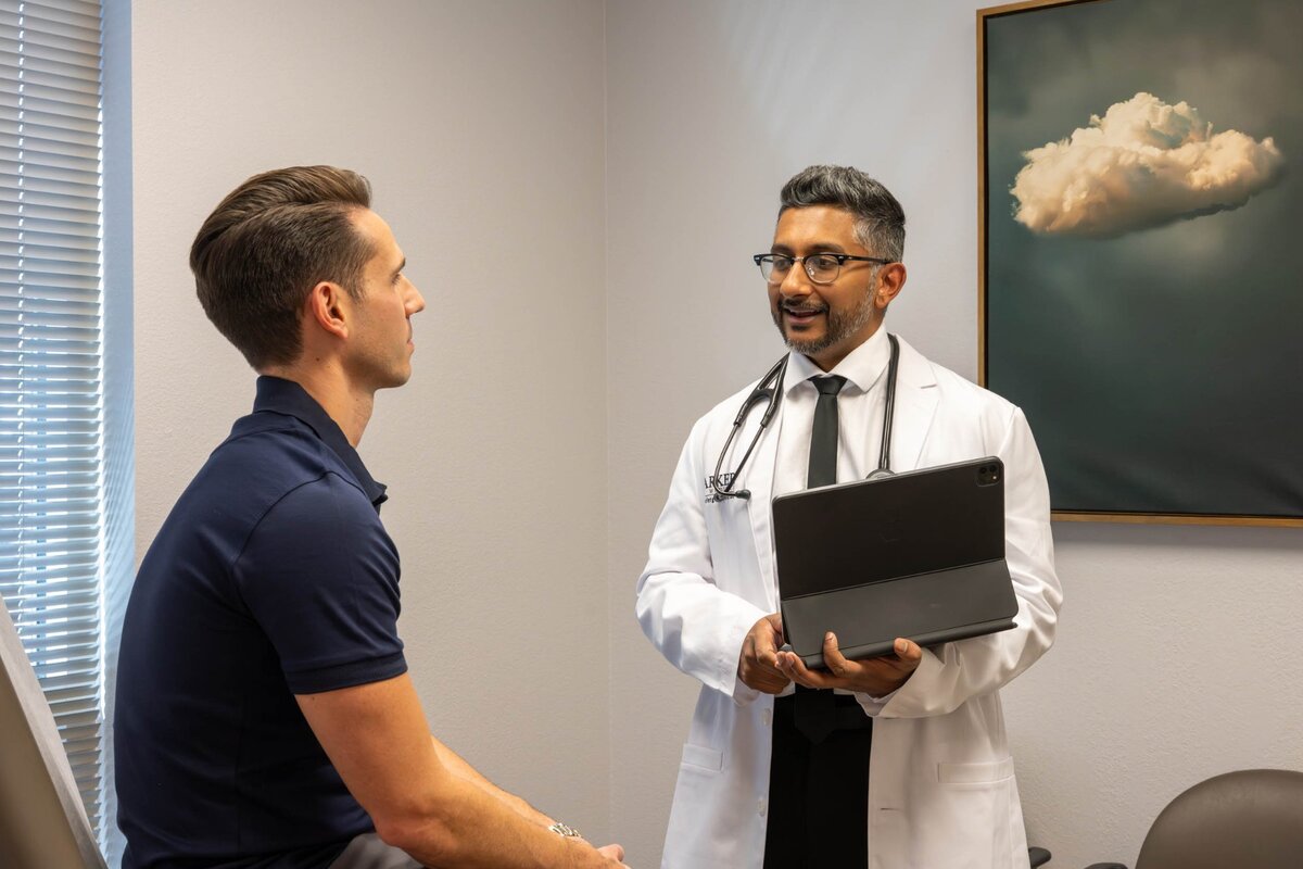 Dr. James Broadbent DO explaining health results to patient during primary care visit at Parker Medical Las Vegas