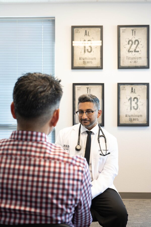 Dr. Tyler George MD consulting with male patient during comprehensive men's health evaluation at Parker Medical Las Vegas